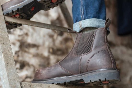 man wearing brown dealer boots on step ladder