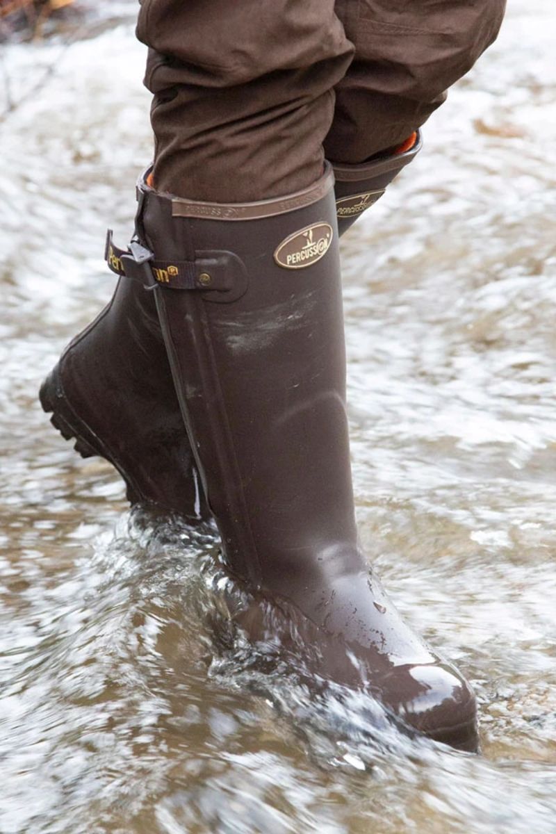 Dog walker wearing Percussion Rambouillet Wellington Boots while walking through a river