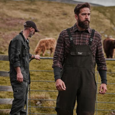 Farmer wearing Hoggs bib and brace waterproof workwear for outdoor farm tasks