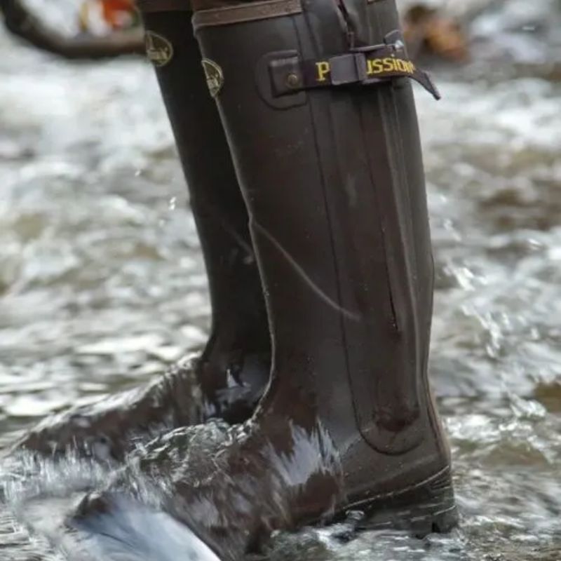Person wearing wellington boots standing in shallow water