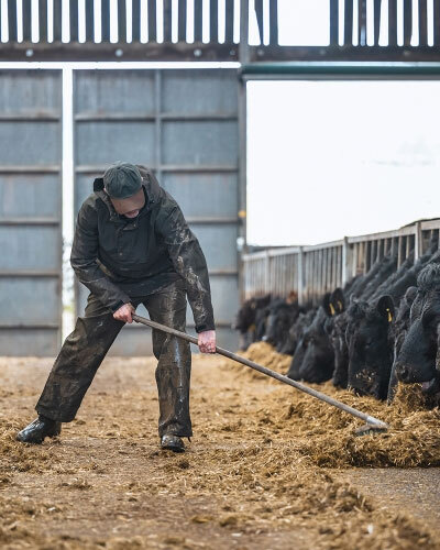 Farmer wearing hoggs waterproof trousers