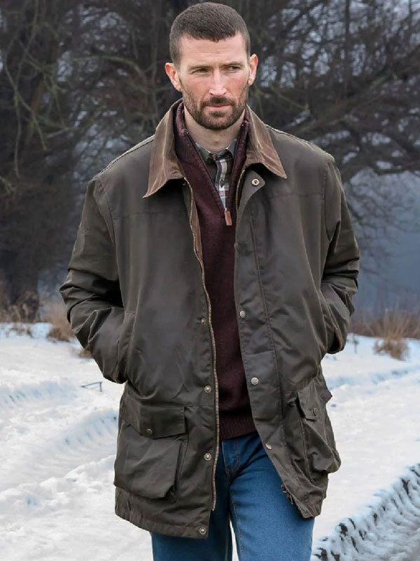 Man wearing waxed barn jacket in the snow