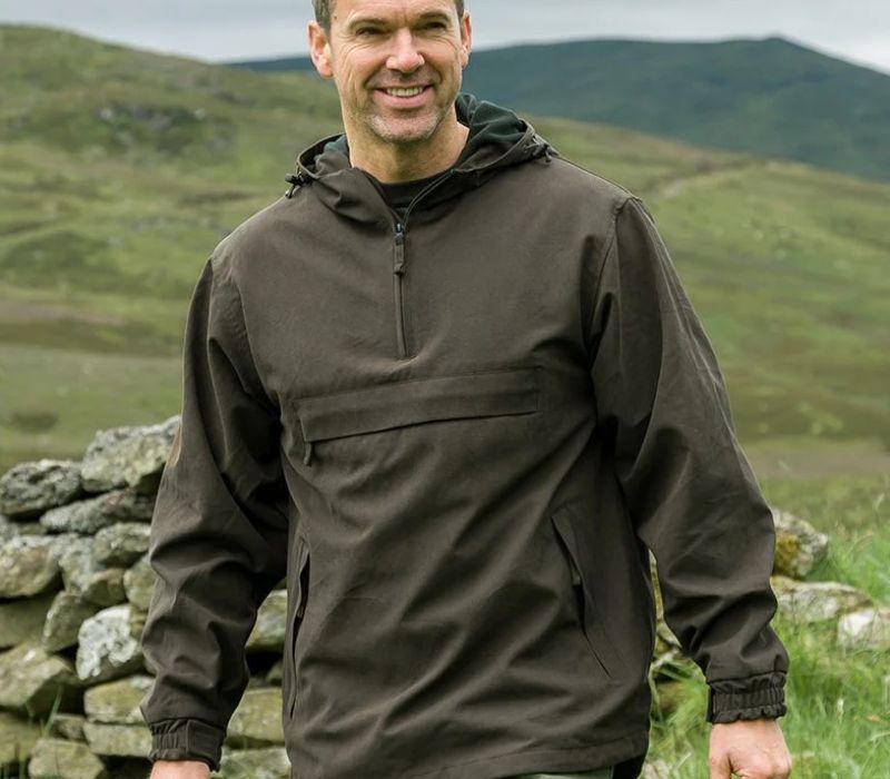 man wearing waterproof smock whilst bird watching