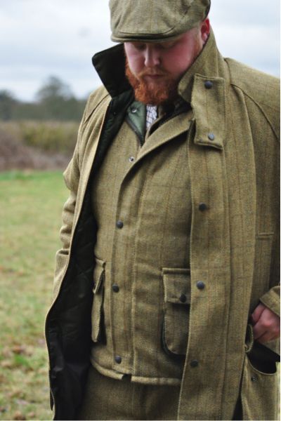 Man wearing traditional tweed shooting jacket for country wear