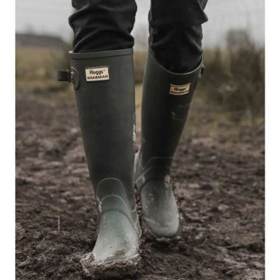 farmer wearing wellingtons on muddy field