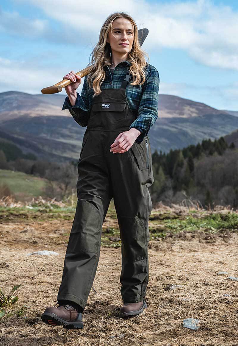 Woman gardening wearing waterproof bib and brace in muddy conditions